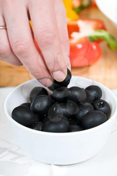 Royalty Free Photo of a Person Holding Olives
