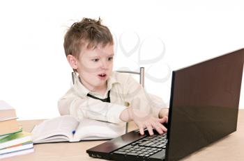a boy pupil works on the laptop