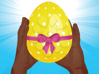 Yellow Decorated Easter Egg with Ribbon and Bow Between Hands