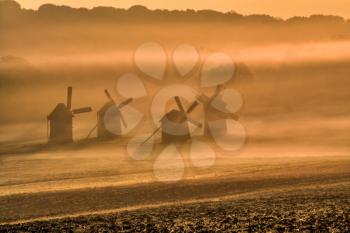 Royalty Free Photo of Windmills in the Fog