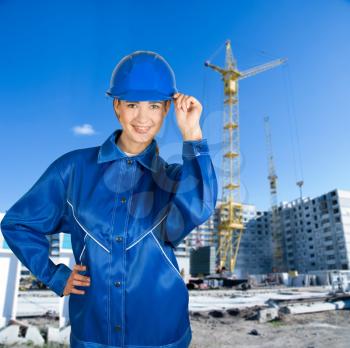 Royalty Free Photo of a Female Builder on a Building Background