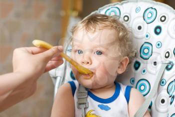 Royalty Free Photo of a Mother Feeding Her Son