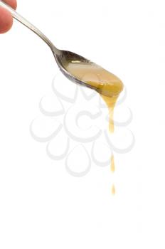 Royalty Free Photo of Honey Dripping on a Spoon