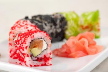 Sushi rolls made of fish avocado and different flying fish roe (tobiko caviar)