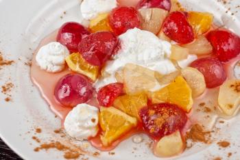 fruit salad of pineapple, grape, orange and strawberry with whipped cream