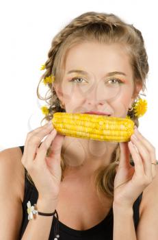 Close-up portrait of young beauty woman eating corn-cob on a white