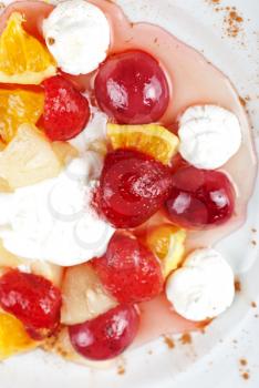 fruit salad of pineapple, grape, orange and strawberry with whipped cream