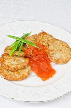 pancakes with red caviar and green onion closeup dish