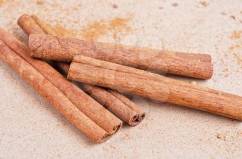 Cinnamon stick closeup on a brown background