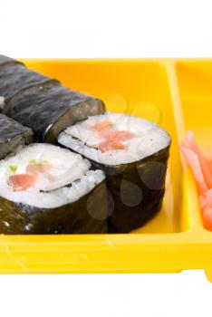 Isolated close up of sushi roll on yellow plate