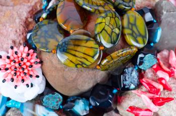 Close up of many different colorful natural gems: agate onyx, coral