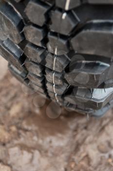 Close up of a car tire on a dirty road.