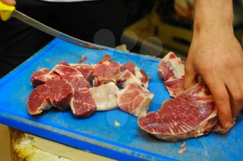 cutting a piece of fresh pork meat