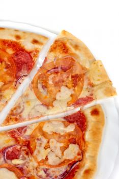 pizza closeup with salami, tomato, onion and mozzarella cheese