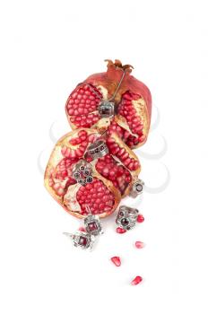 Jewelry and pomegranate on a white