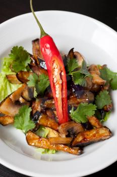 Salad from roasted eggplants, mushrooms, soy sauce, oyster sauce, cilantro and garlic