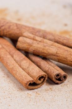 Cinnamon stick closeup on a brown background