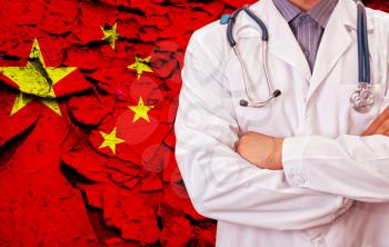 Male doctor on China flag background. Concept of corona virus.