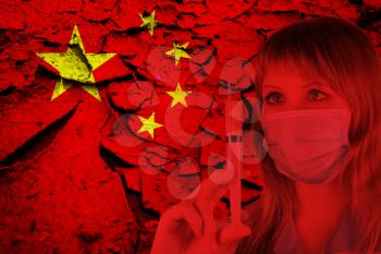 Female doctor with medical mask on China flag background. Concept of corona virus.