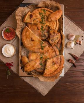 Different pies from meat and vegetables. Freshly baked cakes on a table