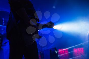 Guitar in the hands of a musician on a rock concert music