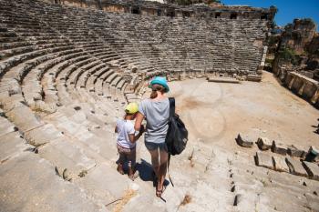 Young woman and her son at theatre in Myra ancient city of Antalya in Turkey.