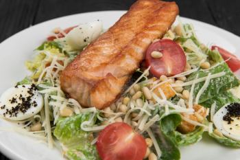 Grilled salmon caesar salad with croutons, parmesan, pine nut and quail egg