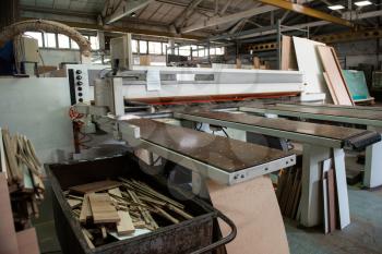 Wooden furniture production. Industrial cutting machine for automatic wood cutting