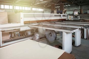 Wooden furniture production. Industrial cutting machine for automatic wood cutting