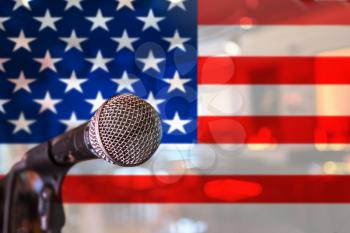 Presentation. or voice concept - microphone on USA flag background.