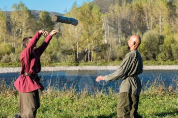 CHARISHSKOE. ALTAISKIY KRAI. WESTERN SIBERIA. RUSSIA - SEPTEMBER 15, 2016: descendants of the Cossacks in the Altai, cossacks play in ancient Slavic national game: throwing timber at the festival on September 15, 2016 in Altayskiy krai, Siberia, Russia.