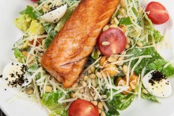 Grilled salmon caesar salad with croutons, parmesan, pine nut and quail egg