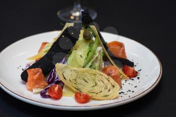 Caesar salad with salmon fish. Tasty restaurant dish