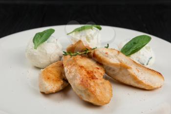 Grilled chicken breast with mozzarella cheese decorated with basil. Concept for a healthy meal.