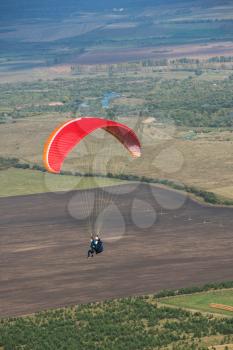 Paragliding in Altai mountains. Paragliders in fight in the mountains, concept of extreme sport activity.