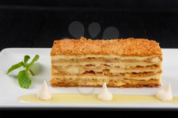 Esterhazy traditional cake on a white plate with mint