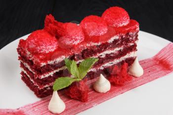 Plate with piece of delicious red velvet cake on white background