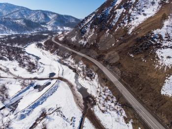 Aerial view of a road in winter landscape of Altai mountains