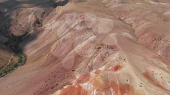Aerial drone 4K video of colorful eroded landform of Altai mountains with yellow, brown and red colors. Nature landscape called Mars, Chagan-Uzun, Altai Republic, Russia