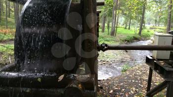 Rustic watermill with wheel being turned by force of falling water from Altai mountain river.