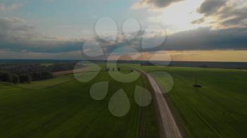 Aerial view of road in summer at sunset. Landscape with road and green grass
