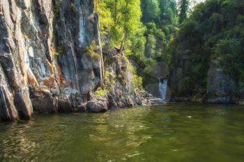 Kishte Waterfall at Lake Teletskoye in autumn Altai Mountains. The most famous lake waterfall