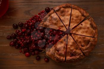 Berries pie with fresh berries and jam on vintage wooden background. Top view