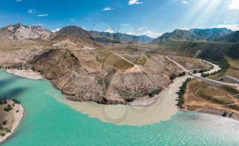 The confluence of two rivers, Katun and Chuya, the famous tourist spot in the Altai mountains, Siberia, Russia, aerial drone shot.