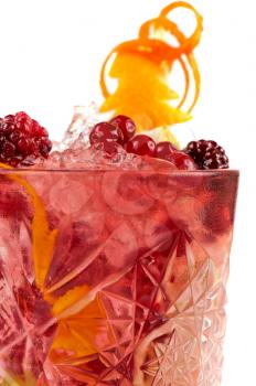 Cocktail with different berries and orange on white