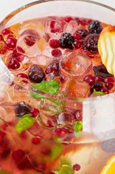 Big cocktail with different fresh berries and fruits