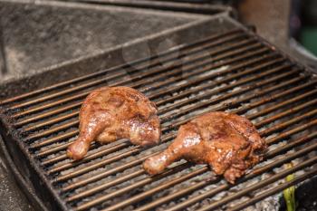 fillet of duck legs on a grill preparing 