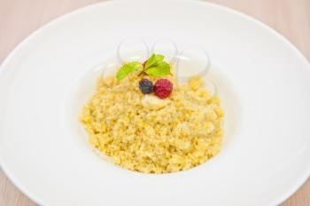 Millet porridge with berry closeup