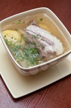 cooked soup with lamb meat, potatoes and vegetables 