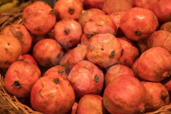 Counter with ripe pomegranates in supermarket 